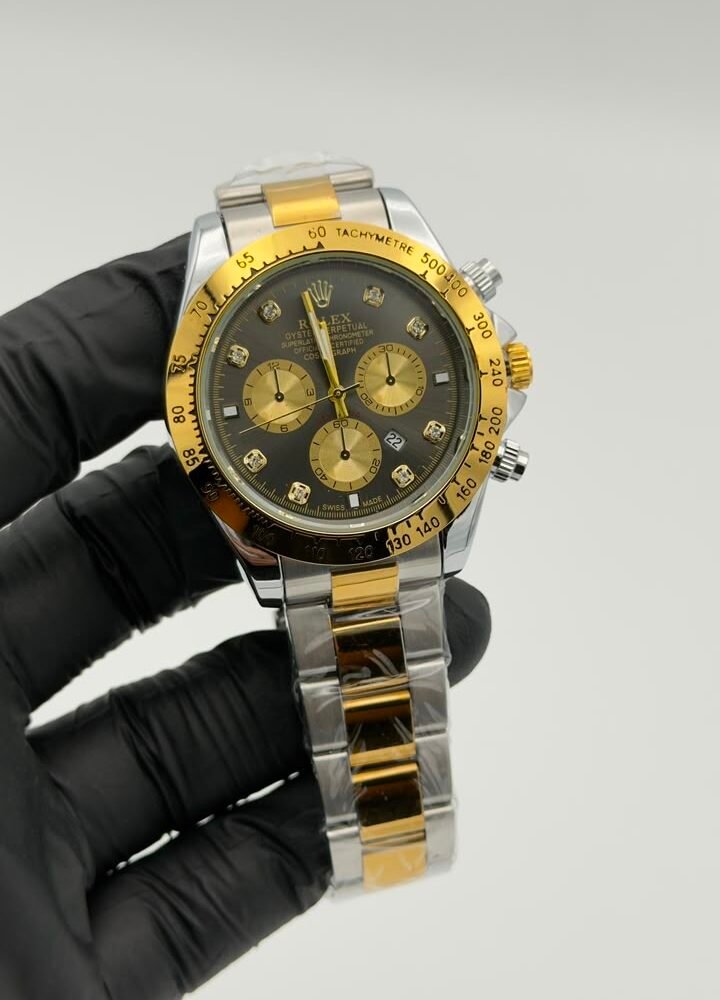 Black dial gold-tone chronograph style quartz watch with two-tone bracelet Black Dial Gold-Tone Chronograph Style Quartz Watch