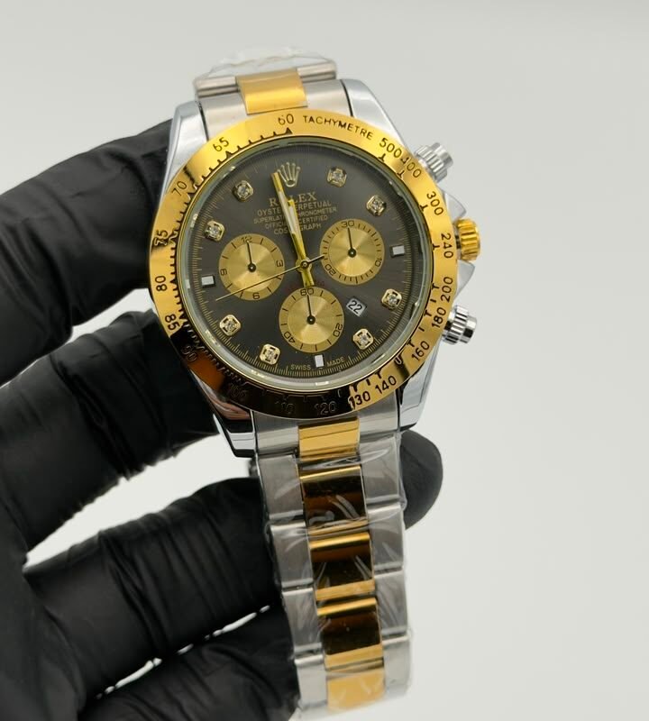 Black dial gold-tone chronograph style quartz watch with two-tone bracelet Black Dial Gold-Tone Chronograph Style Quartz Watch