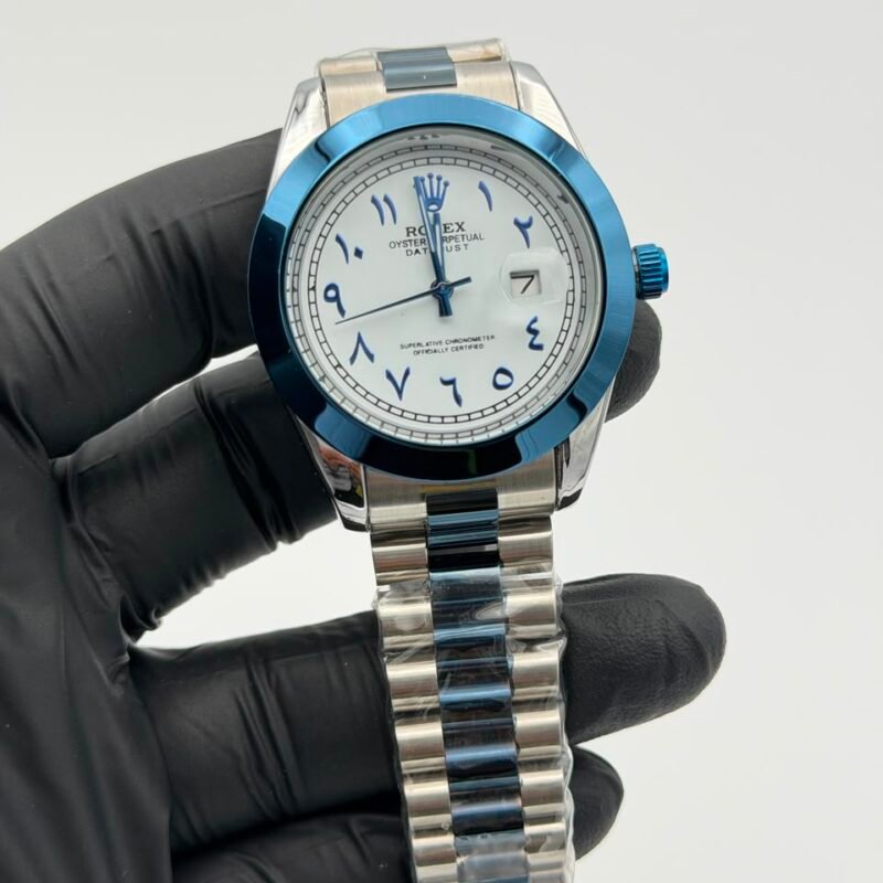 White-dial-blue-accent-watch-with-Arabic-style-numerals-and-stainless-steel-bracelet.jpeg White Dial Blue Accent Watch – Stainless Steel Bracelet